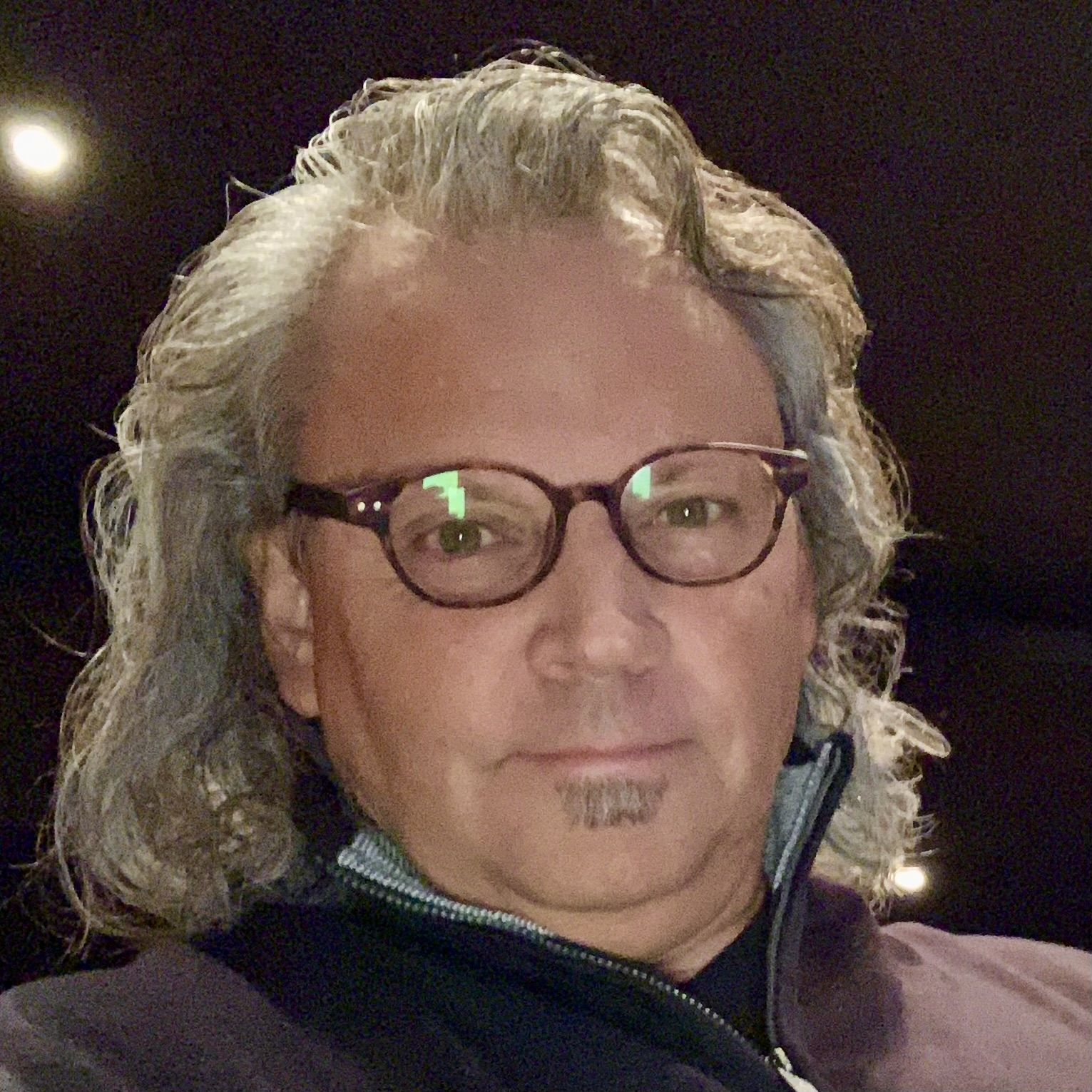 A man with long gray hair and glasses, wearing a pullover shirt. Individual is Douglas P. Fish, the Founder, Steward and CEO of Fish Stewarding Group.